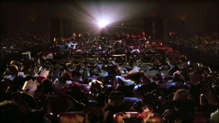 Fotograma de la Icónica escena de 'Gremlins' de 1984, en donde las malvadas criaturas se divierten y cantan, mientras ven la pelìcula de 'Blancanieves' de 1938.